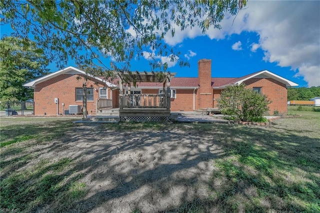 single story home featuring central AC, a deck, and a front lawn