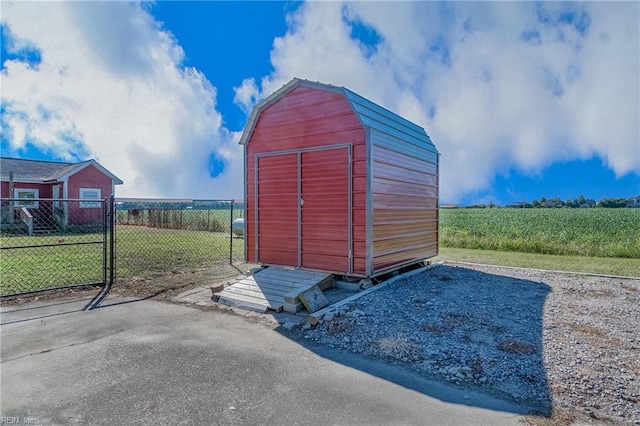 view of outdoor structure featuring a yard and a rural view