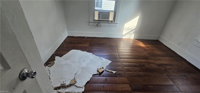 empty room with cooling unit and dark hardwood / wood-style floors