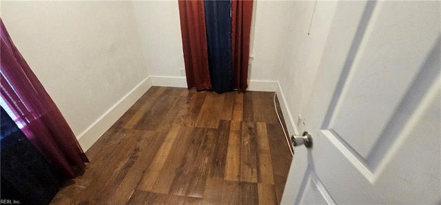 hallway featuring dark hardwood / wood-style flooring