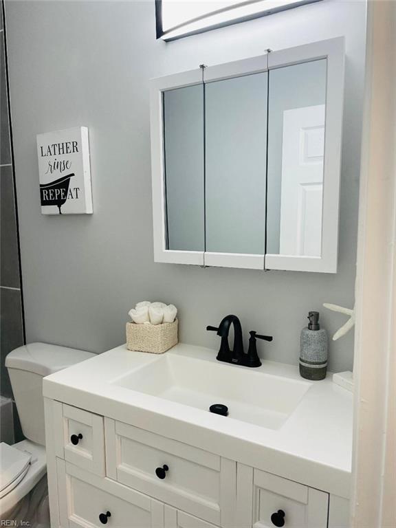 bathroom featuring toilet and vanity