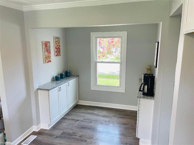 interior space with dark wood-type flooring and crown molding