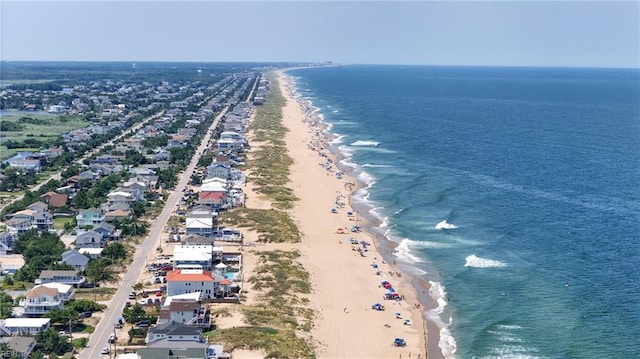 drone / aerial view featuring a beach view and a water view