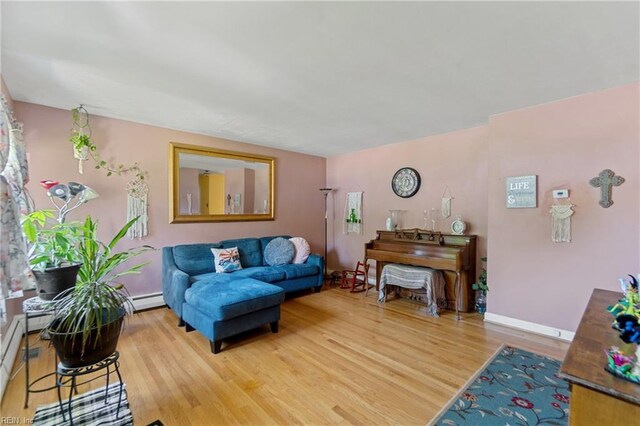 living room featuring baseboard heating and light wood-type flooring