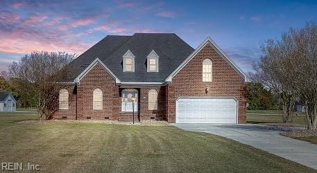 cape cod house with a front yard, crawl space, brick siding, and driveway