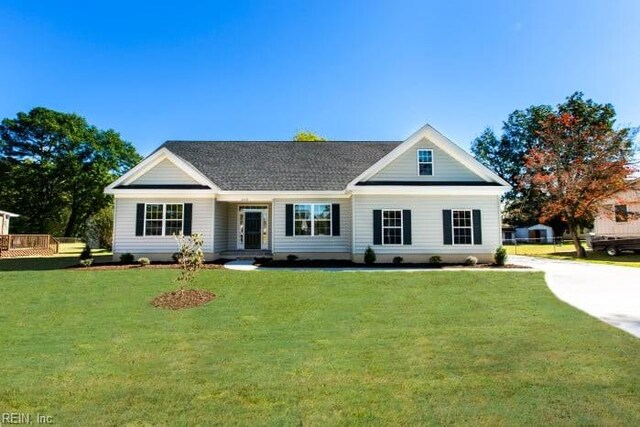 view of front facade with a garage, a front yard, and covered porch