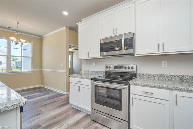 kitchen with white cabinetry, light hardwood / wood-style flooring, stainless steel appliances, hanging light fixtures, and ornamental molding