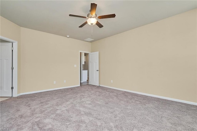 carpeted spare room with ceiling fan