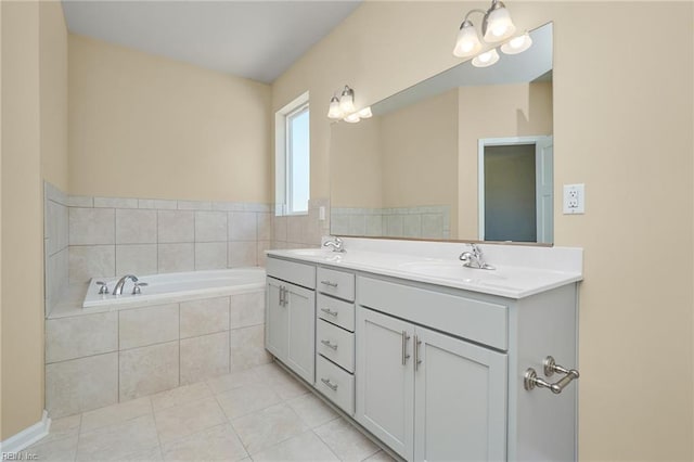 bathroom with tiled bath, tile patterned floors, and double vanity