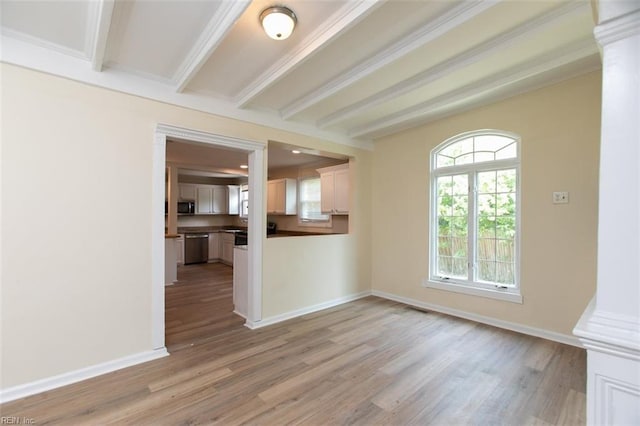 unfurnished living room with beamed ceiling, ornamental molding, decorative columns, and light wood-type flooring