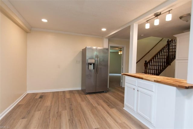 kitchen featuring white cabinetry, butcher block counters, stainless steel fridge with ice dispenser, rail lighting, and light hardwood / wood-style flooring