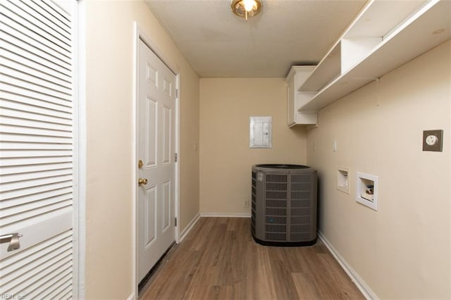 washroom featuring hookup for an electric dryer, washer hookup, hardwood / wood-style floors, and electric panel