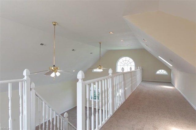 additional living space featuring light carpet, ceiling fan, and lofted ceiling