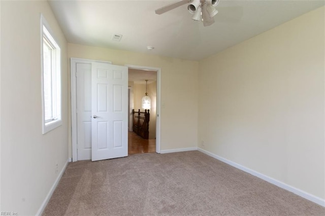 unfurnished bedroom featuring carpet and ceiling fan