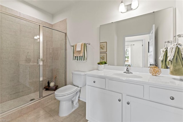 bathroom with walk in shower, vanity, toilet, and tile patterned flooring