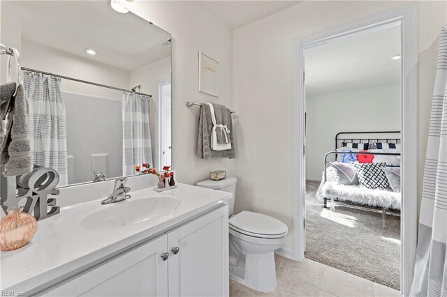 bathroom with vanity, a shower with curtain, tile patterned floors, and toilet