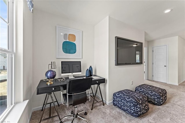 carpeted home office with a healthy amount of sunlight