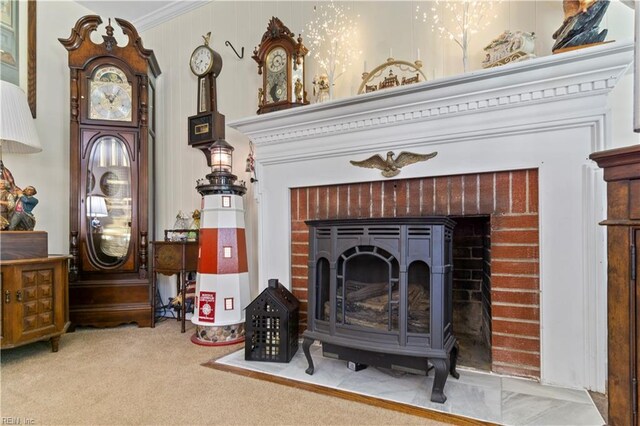 interior details with ornamental molding, a wood stove, and carpet