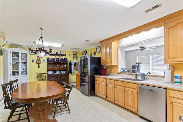 kitchen with light tile patterned flooring, dishwasher, hanging light fixtures, black fridge, and sink