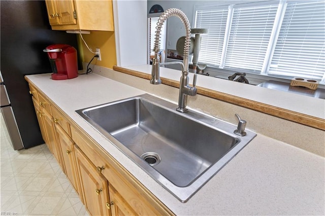 kitchen featuring sink and light tile patterned floors