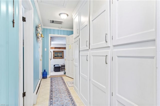 corridor with crown molding and light tile patterned floors