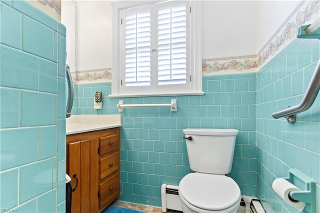 bathroom with tile walls, tile patterned floors, toilet, a baseboard radiator, and vanity