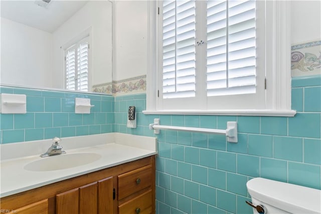 bathroom featuring tile walls and toilet