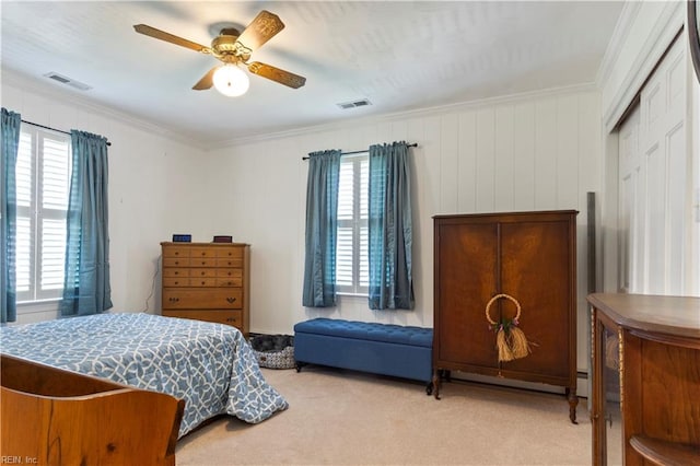 carpeted bedroom featuring ceiling fan, ornamental molding, and a closet