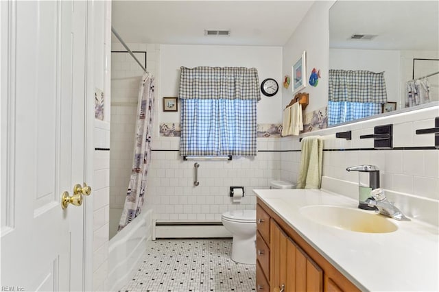 full bathroom featuring shower / tub combo with curtain, vanity, tile walls, a baseboard heating unit, and toilet