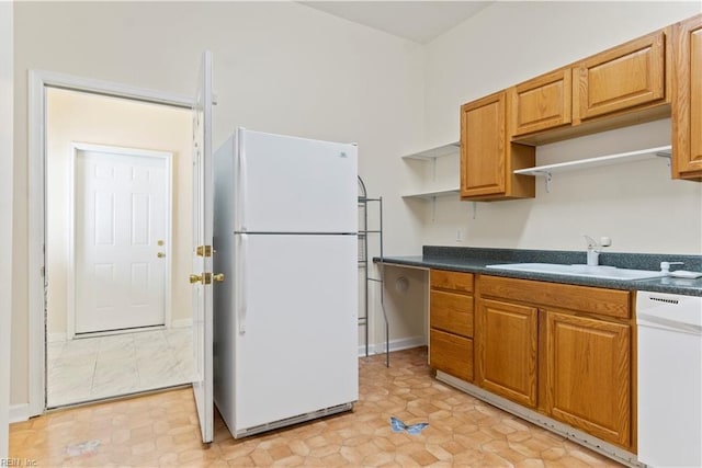 kitchen featuring light tile patterned flooring, sink, and white appliances