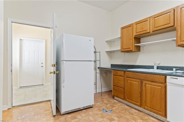 kitchen featuring white appliances, a sink, open shelves, dark countertops, and brown cabinets