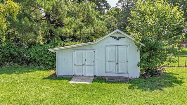 view of outbuilding featuring a lawn