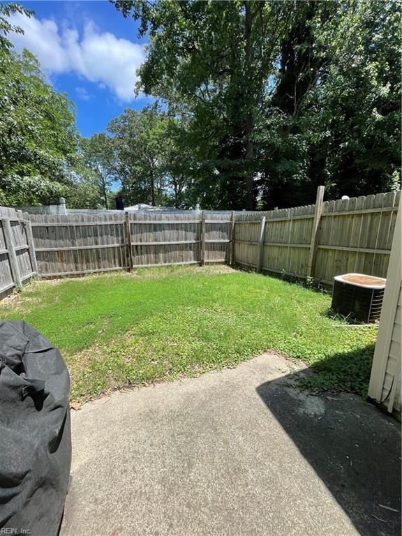 view of yard featuring cooling unit, a patio, and a fenced backyard