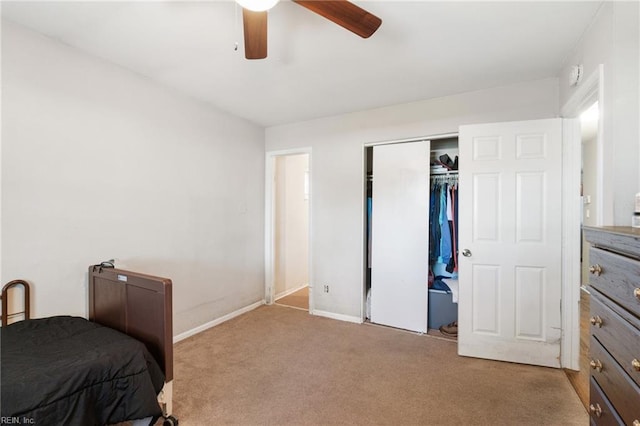 carpeted bedroom with a closet and ceiling fan