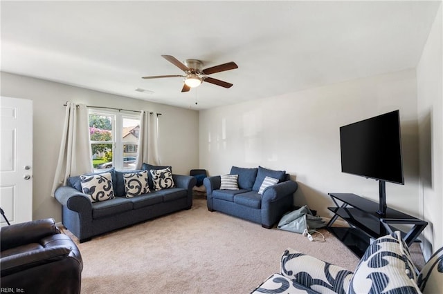 carpeted living room featuring ceiling fan