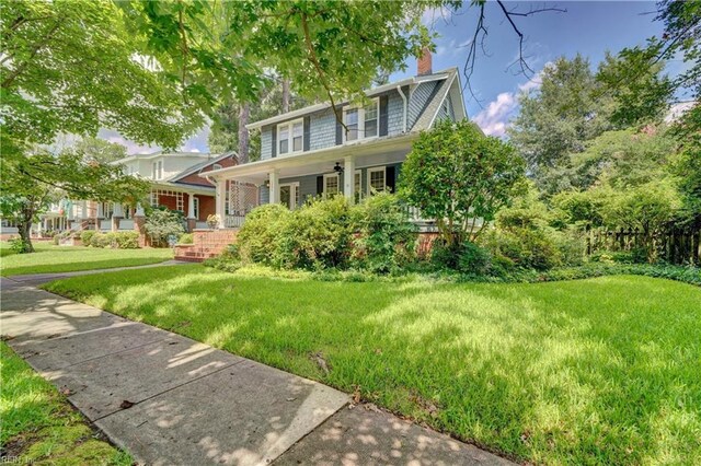 view of front of property with covered porch and a front yard