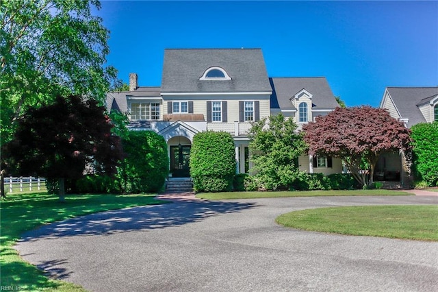 view of front of house with a front lawn and french doors