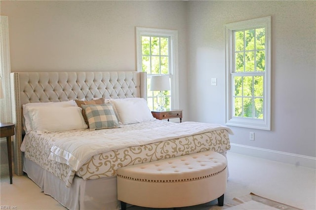 carpeted bedroom with multiple windows