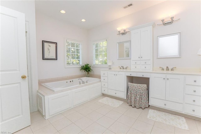 bathroom featuring vanity, tile patterned floors, and a tub