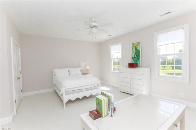 bedroom featuring light colored carpet and ceiling fan