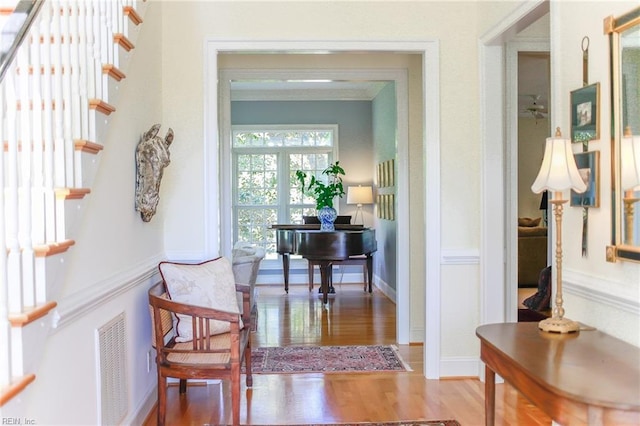 corridor with crown molding and hardwood / wood-style flooring