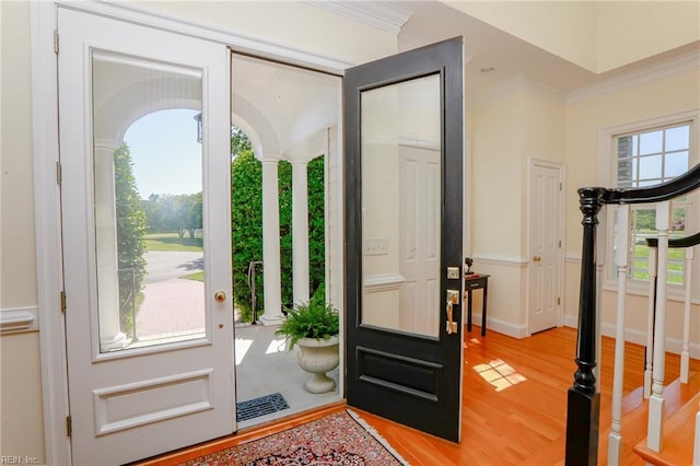 foyer entrance featuring ornamental molding and light hardwood / wood-style floors