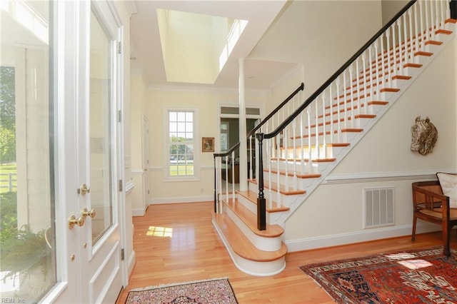 entryway featuring hardwood / wood-style floors and ornamental molding