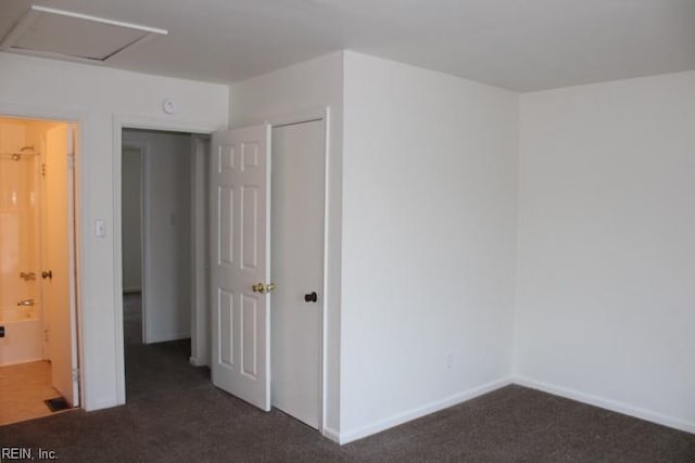 unfurnished room with dark carpet