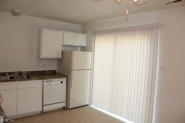 kitchen featuring sink, white appliances, ceiling fan, white cabinetry, and dark stone countertops