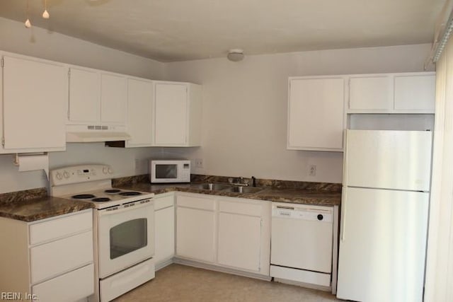 kitchen with white cabinetry, white appliances, sink, and dark stone countertops