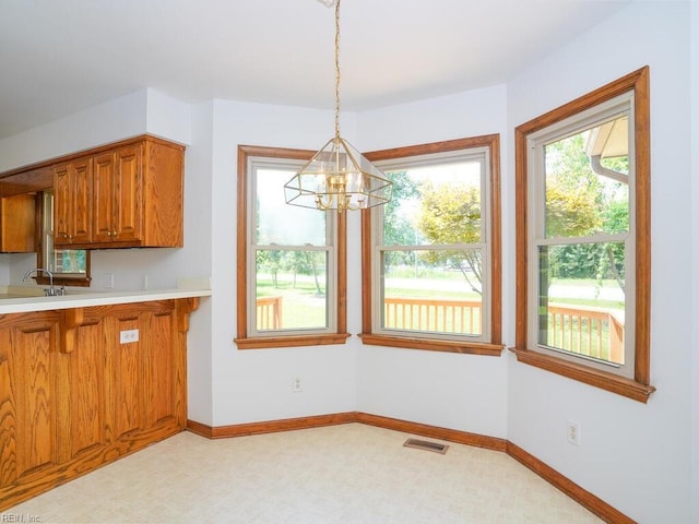 kitchen with an inviting chandelier, decorative light fixtures, and sink