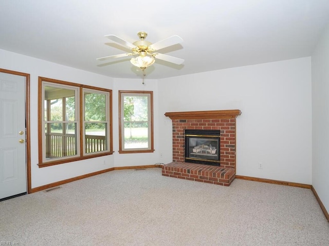 unfurnished living room featuring ceiling fan, carpet flooring, and a fireplace