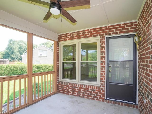 unfurnished sunroom with ceiling fan