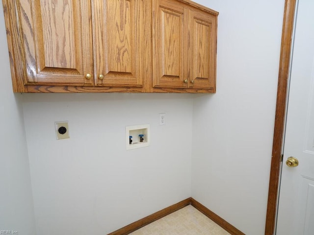 laundry area with electric dryer hookup, hookup for a washing machine, and cabinets